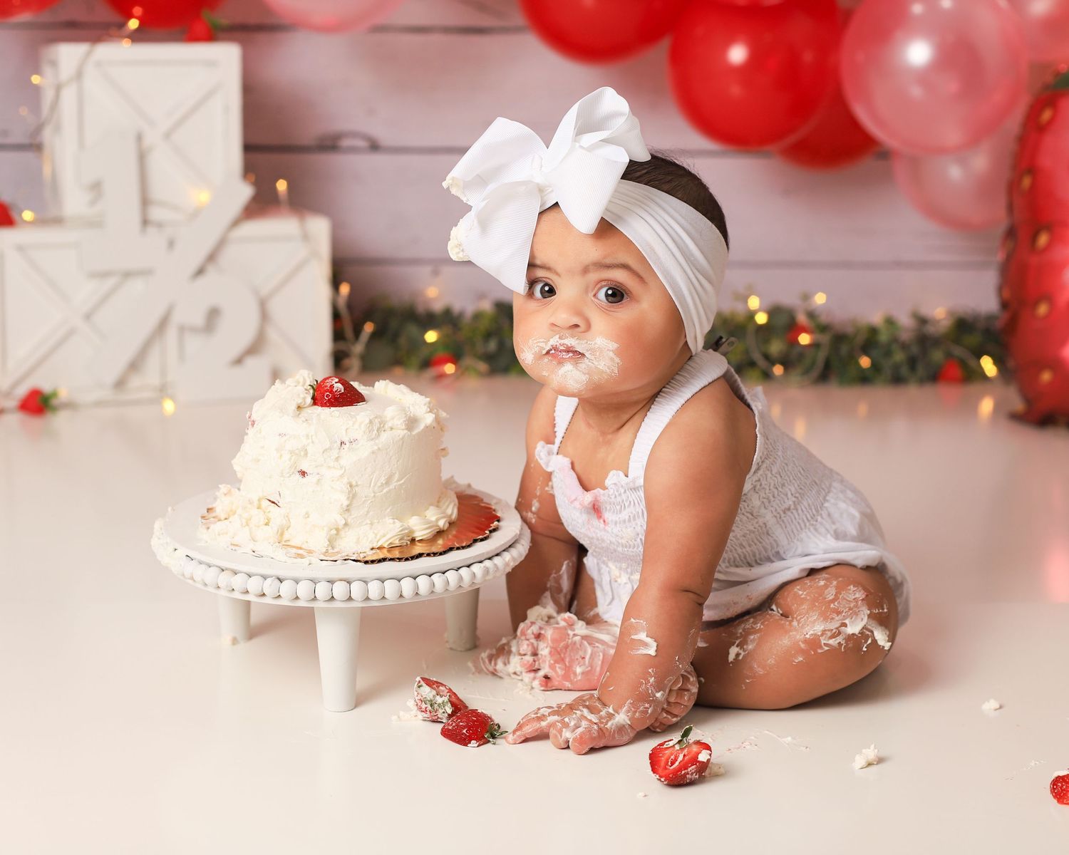 Cute little half birthday cake smash with strawberry theme taken in my studio in Lexington, SC.