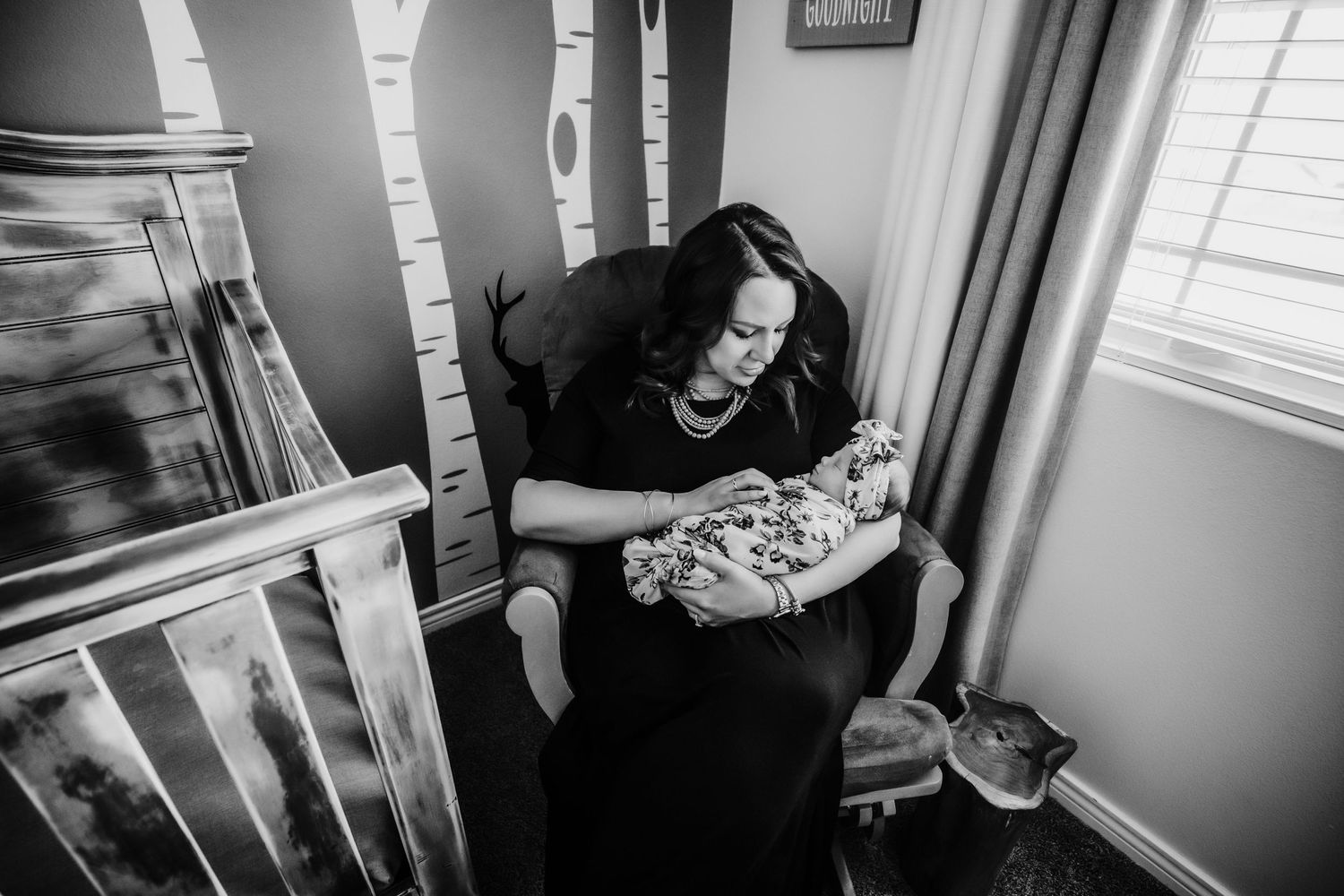 New mom holding her newborn baby in the nursery in Dickson, TN