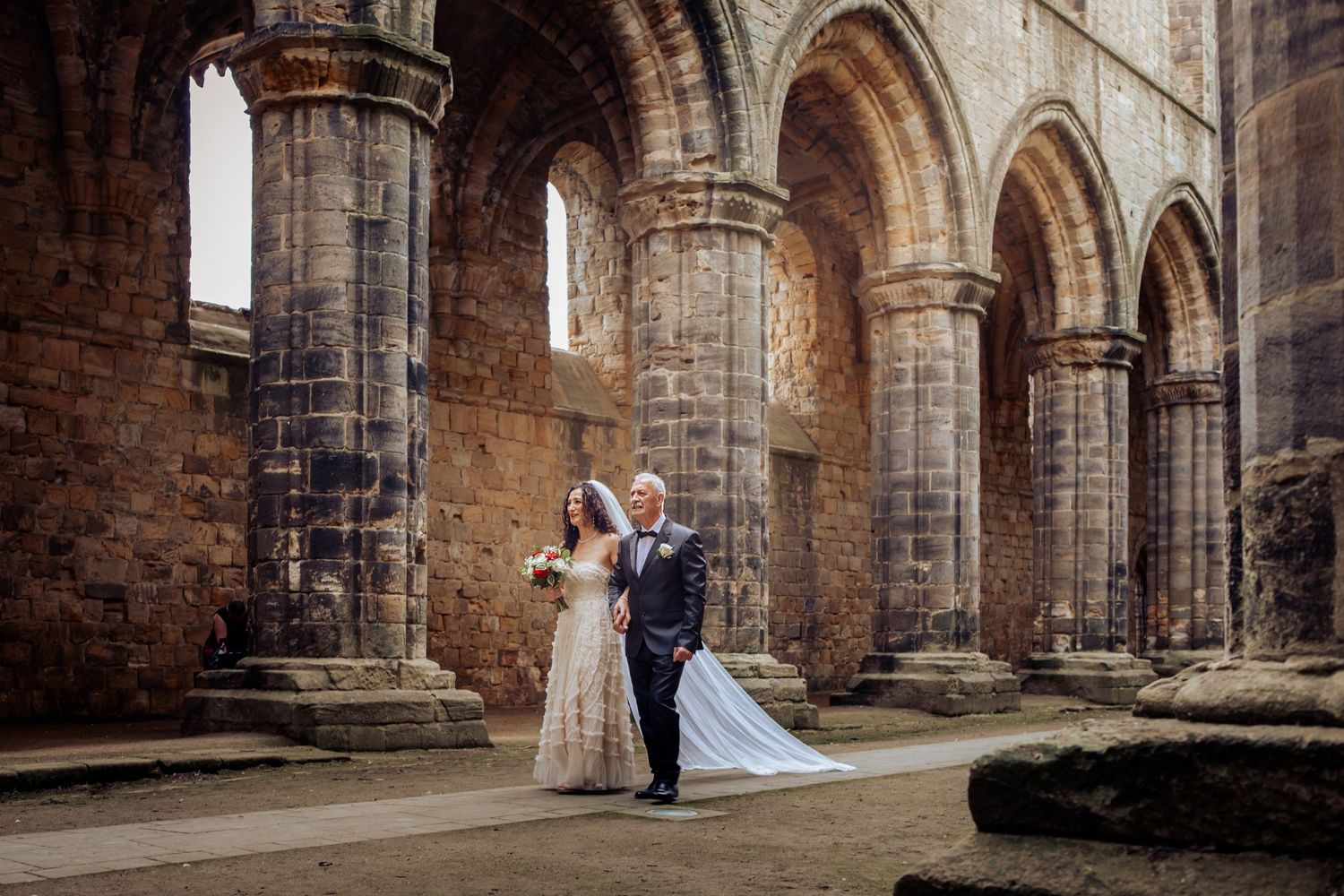 farther walks the bride down the aisle at kirkstall abbey in leeds a timeless memory