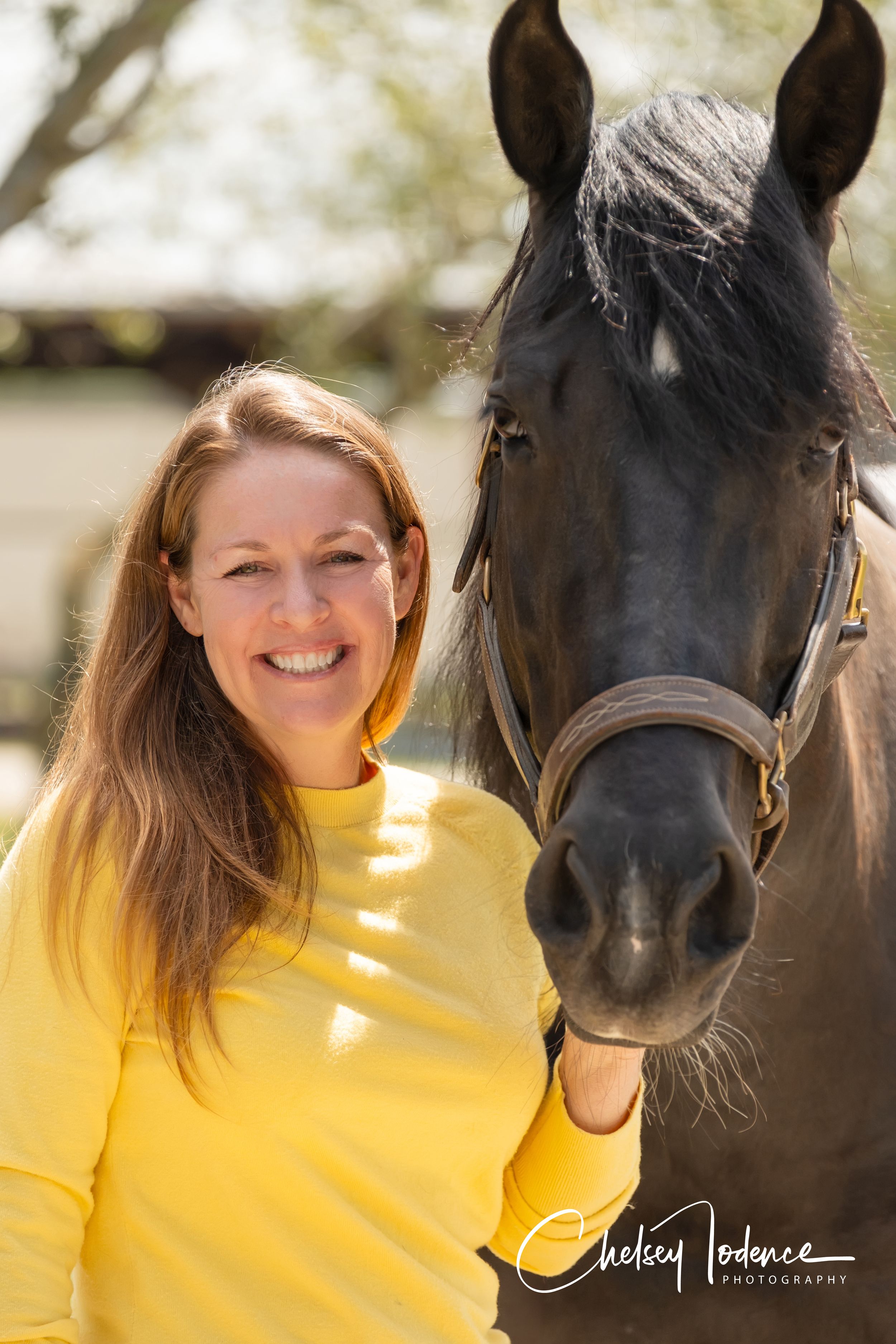 Equine portrait of a smiling woman with her horse at Strides Riding Academy in Petaluma, CA, captured by an equine photographer