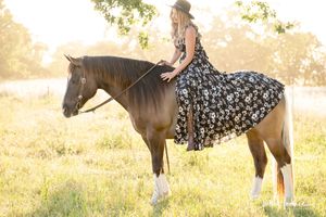 Fine art equine portrait of a woman sitting bareback on her horse in a flowing dress, photographed in natural light in Sonoma