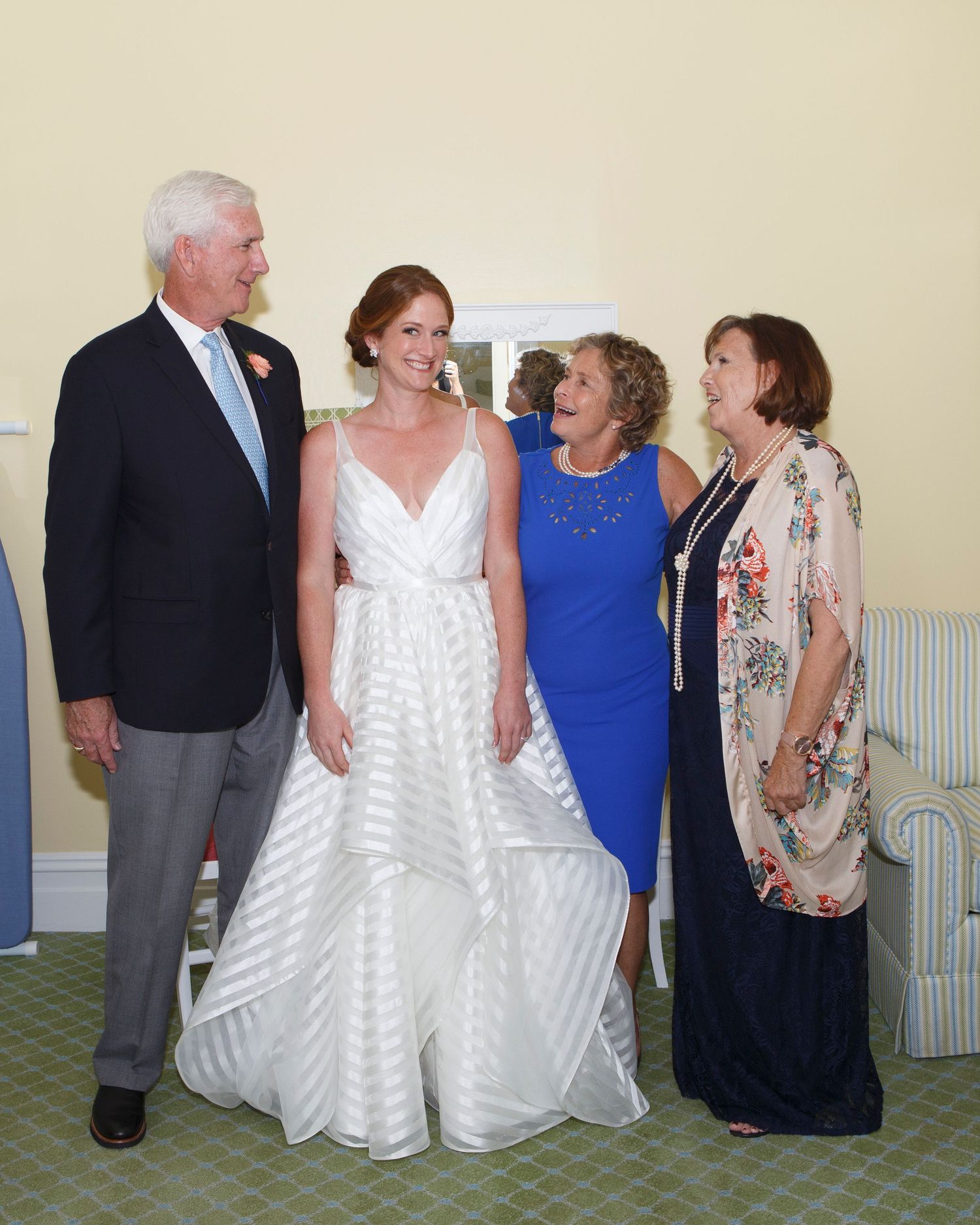 Bride poses with family members in elegant wedding portrait indoors. Gasparilla Inn