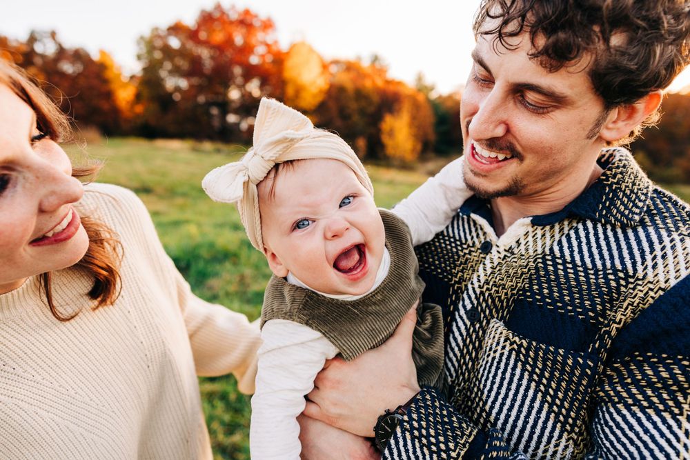 Candid family interactions filled with laughter during a fall photo session.
