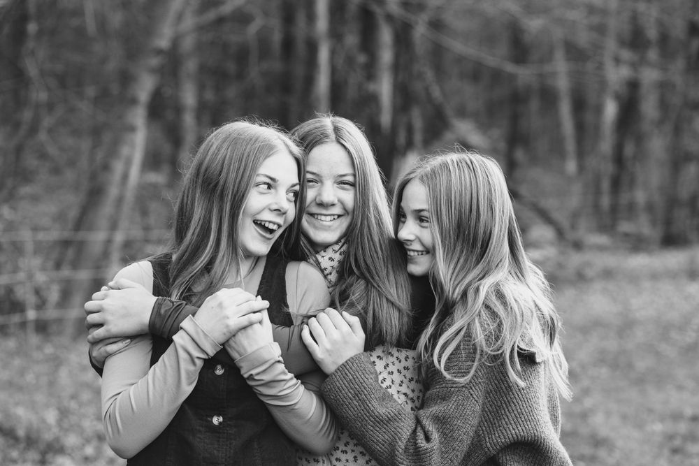 Black and white portrait showing genuine laughter and connection between friends.