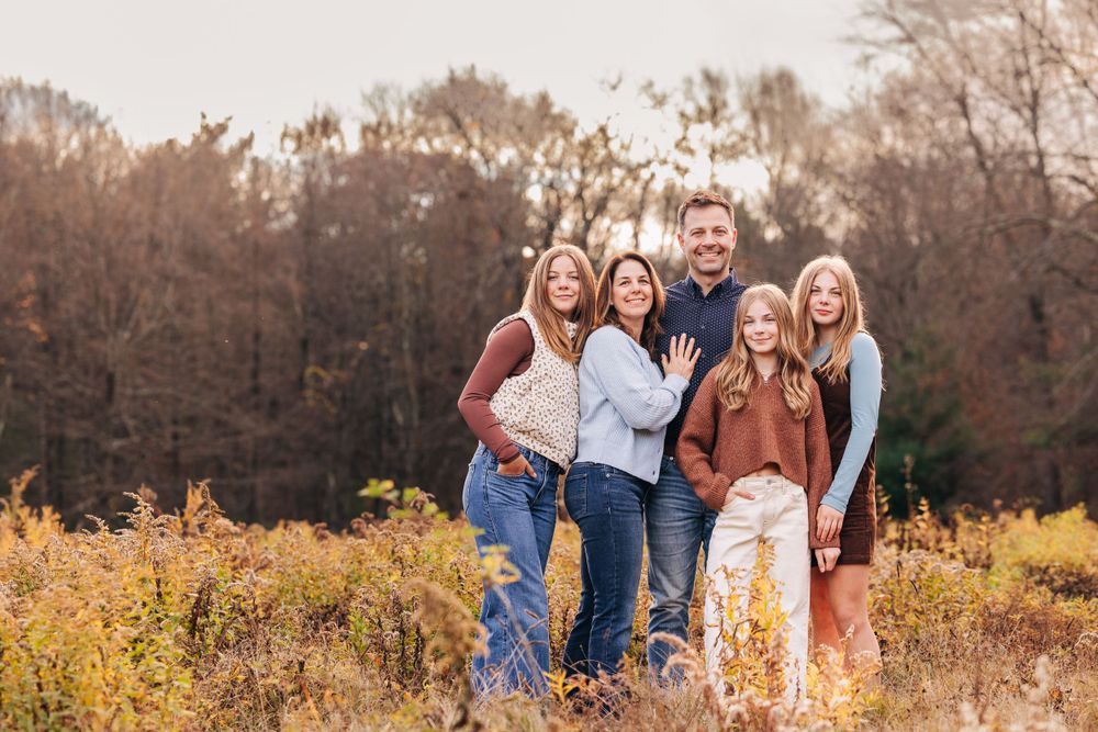 Natural outdoor group portraits in a field during autumn season.