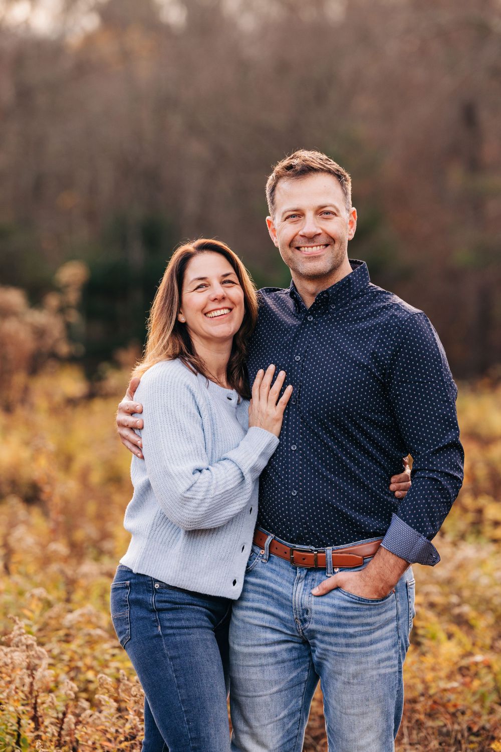 Casual outdoor portraits with natural expressions against fall foliage.