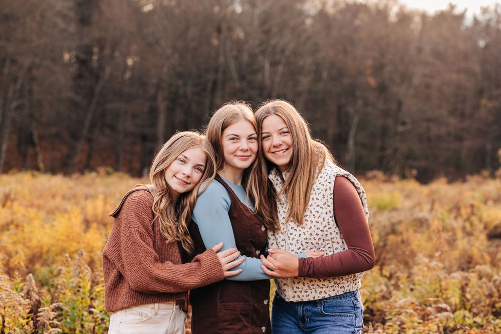 Casual outdoor portraits with warm autumn colors in a natural setting.