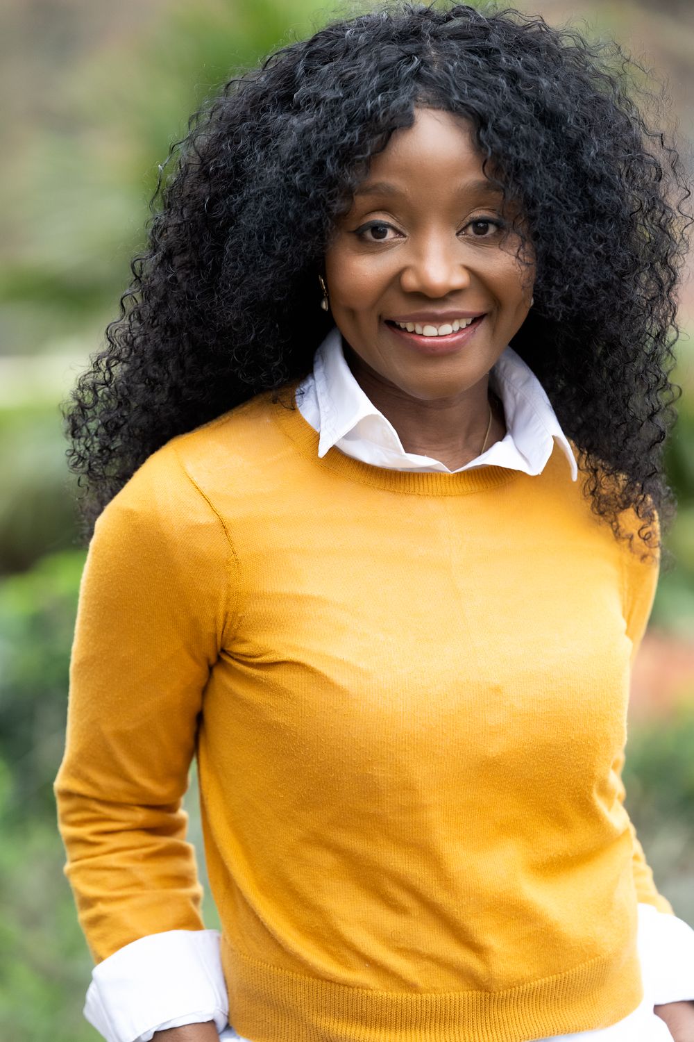 A series of five similar photos showing someone in a bright yellow sweater and white collared shirt against a blurred background.