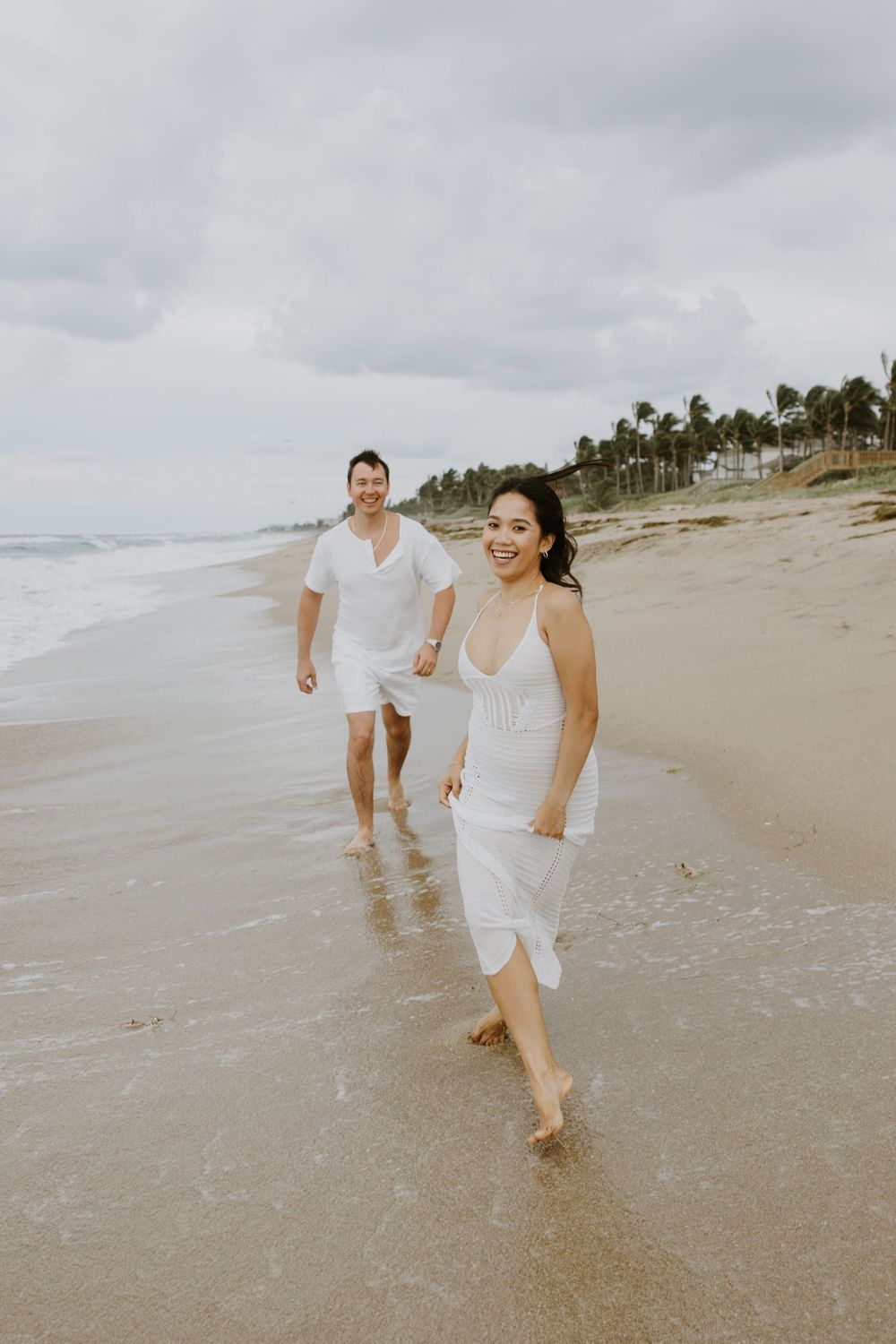 Sunrise couple pregnancy announcement photos at the beach on Palm Beach Island captured by Lindsay McDow Photography.