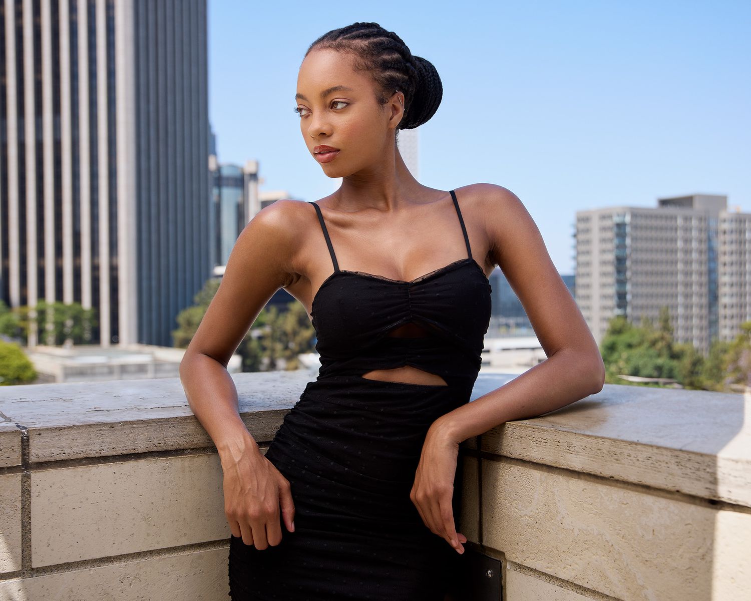 Urban fashion portrait in black dress against downtown skyscraper backdrop, at Disney Music Hall LA