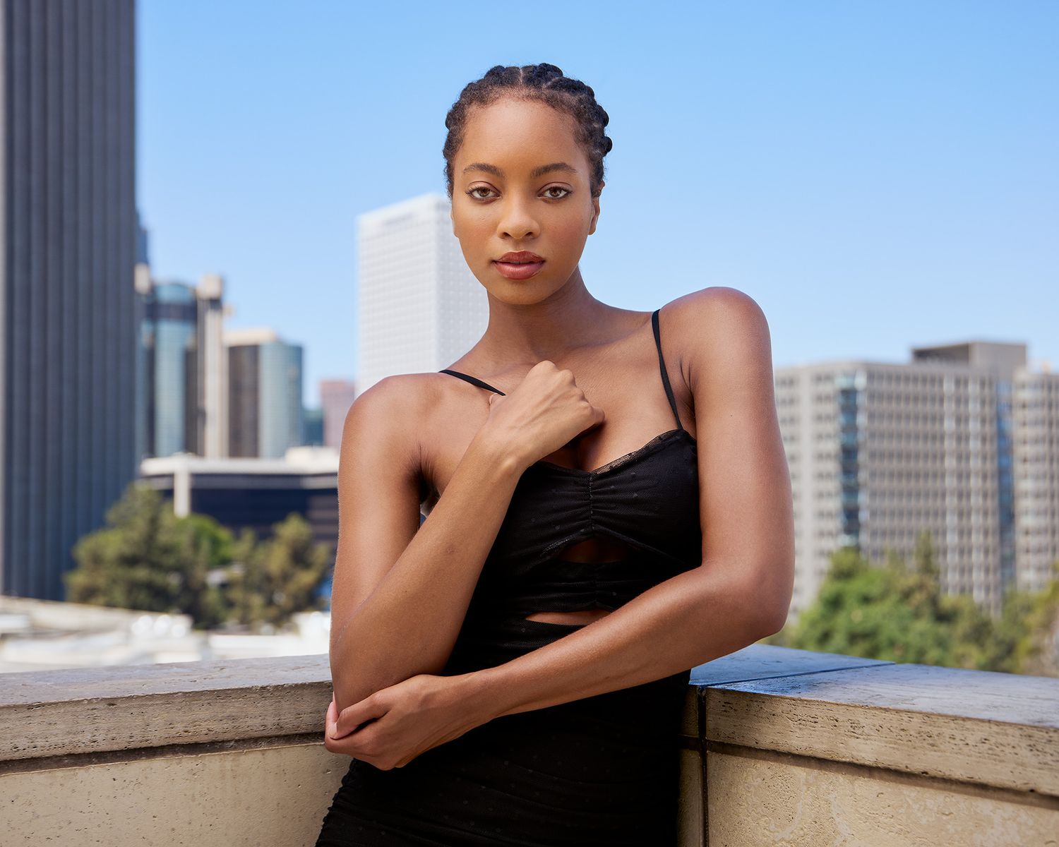 Urban fashion portrait in black dress against downtown skyscraper backdrop, at Disney Music Hall LA