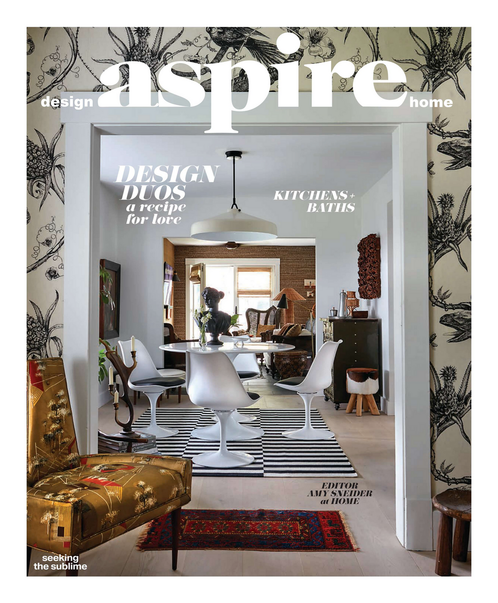 Magazine cover showing a modern interior design with black and white geometric patterns and stylish furniture.
