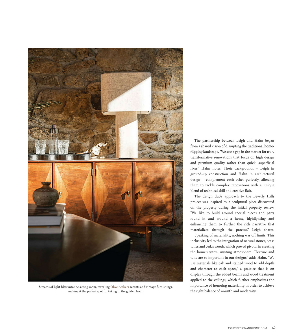 Stone wall interior with wooden cabinet and table featuring ambient lighting and glassware display.