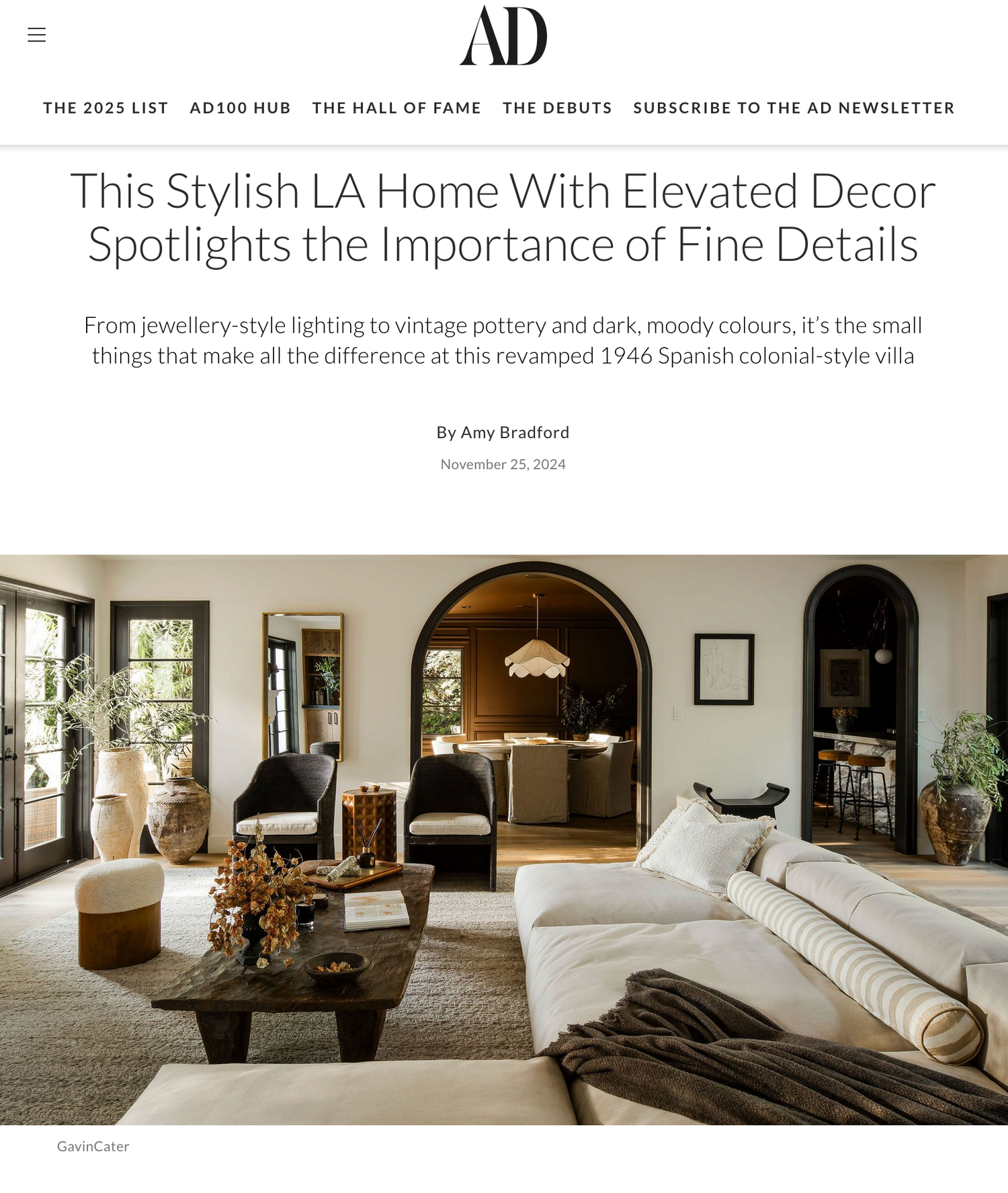 Modern LA living room with arched doorways, white sectional sofa, dark coffee table and elegant decor details.