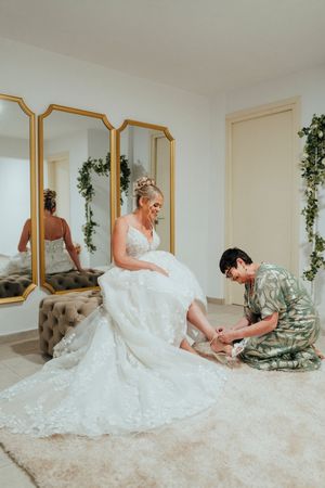 A sequence of photos showing someone in a white lace wedding dress lounging on a tufted sofa with decorative greenery.