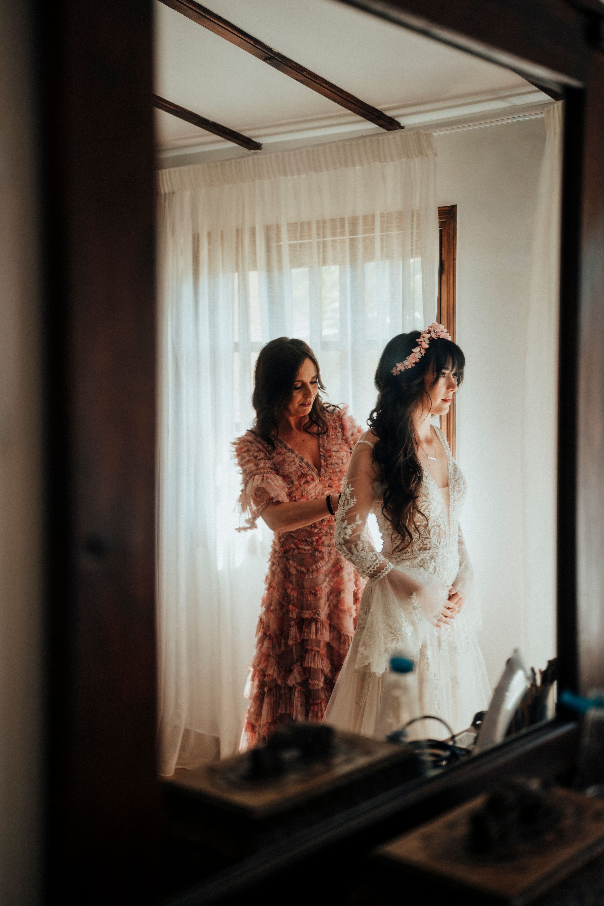Three sequential frames show silhouettes against a bright window with sheer curtains in a dimly lit room.