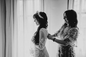 A series of silhouettes against white curtains show people dancing and moving in graceful poses.