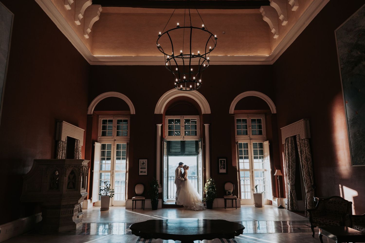 Interior of a historic building with arched doorways and dramatic lighting.