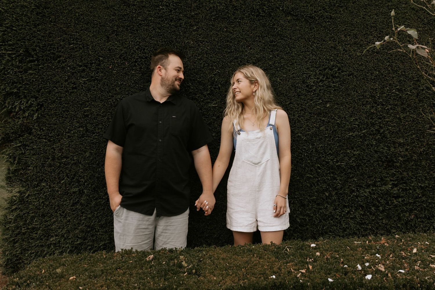 Series of couples posing against a dark backdrop in casual attire.