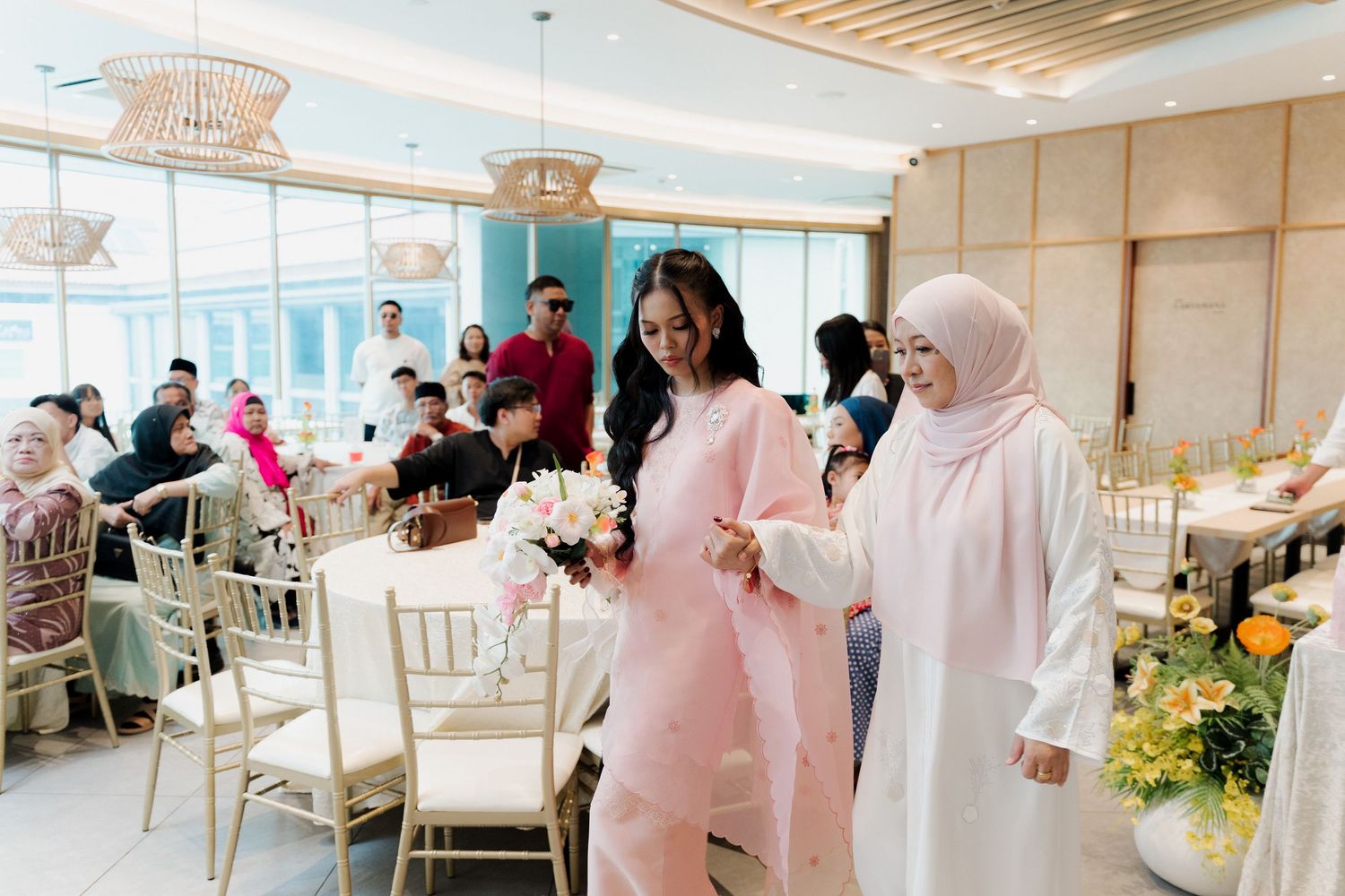 A group celebration scene with people interacting and posing together indoors.