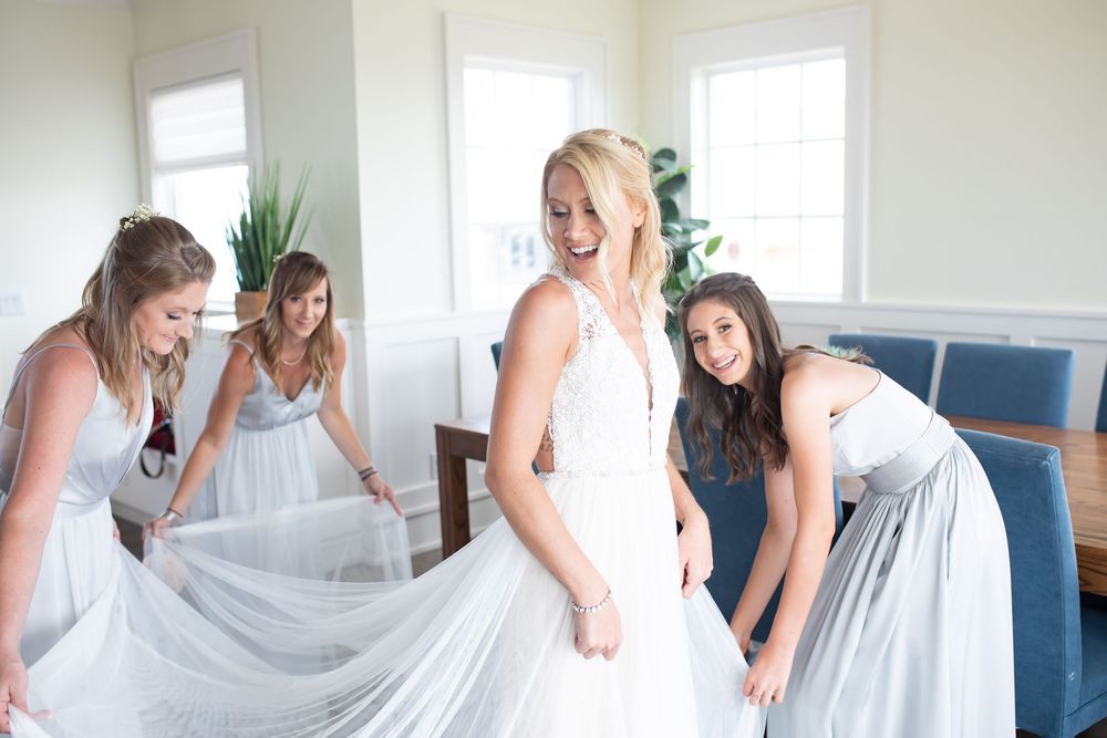 A series of photos showing a bride getting ready with her bridal party in a bright white room.