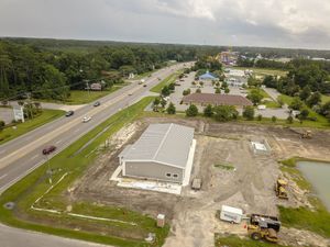 Bird's eye view of a construction site with partially completed buildings and roads.