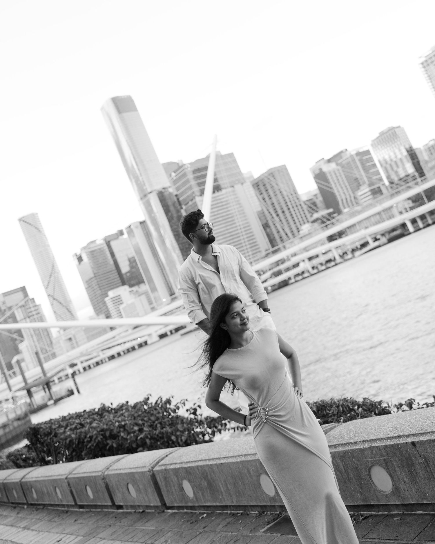 Black & white dress poses against city skyline waterfront, beautifully captured by the best wedding photographer in Mumbai near you