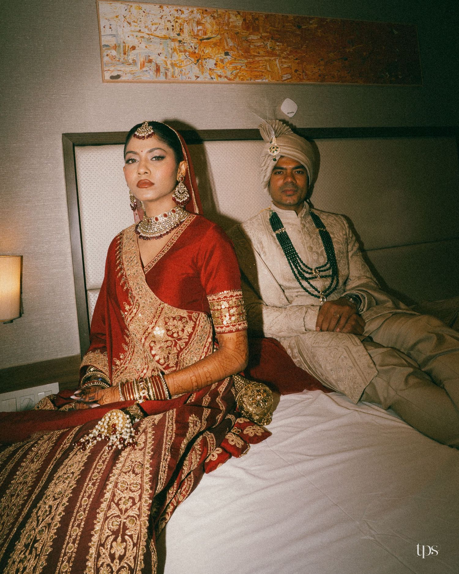 Indian bride in red lehenga, groom in white sherwani captured by the best wedding photographer in Mumbai. Your wedding photographer near me.