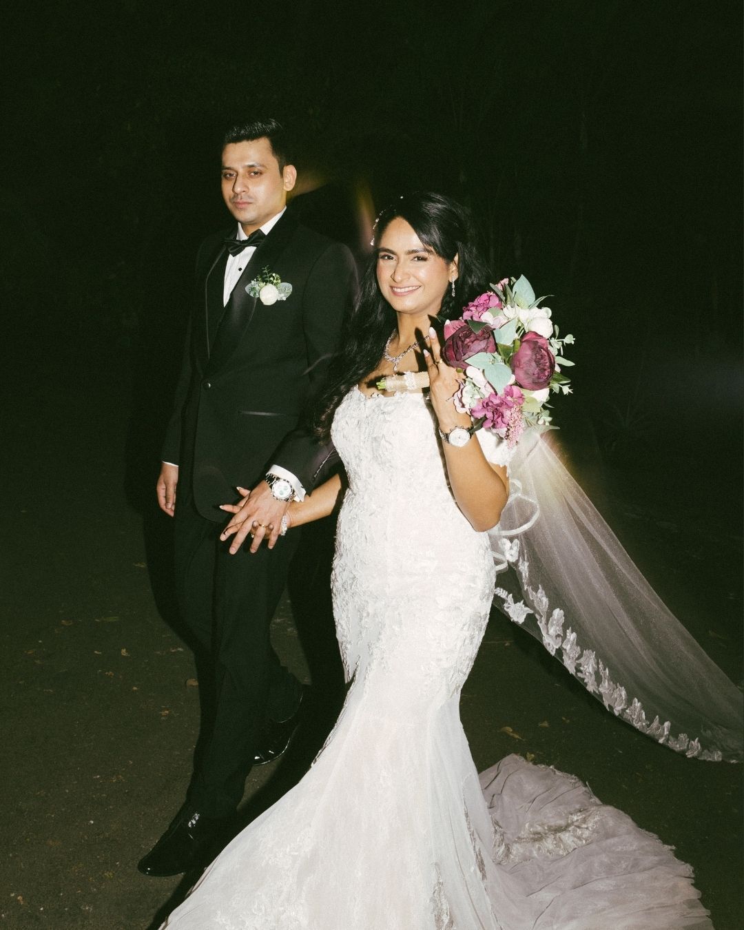 Couple dancing outdoors at night with flowing veil movement, beautifully captured by a professional wedding photographer in Mumbai.