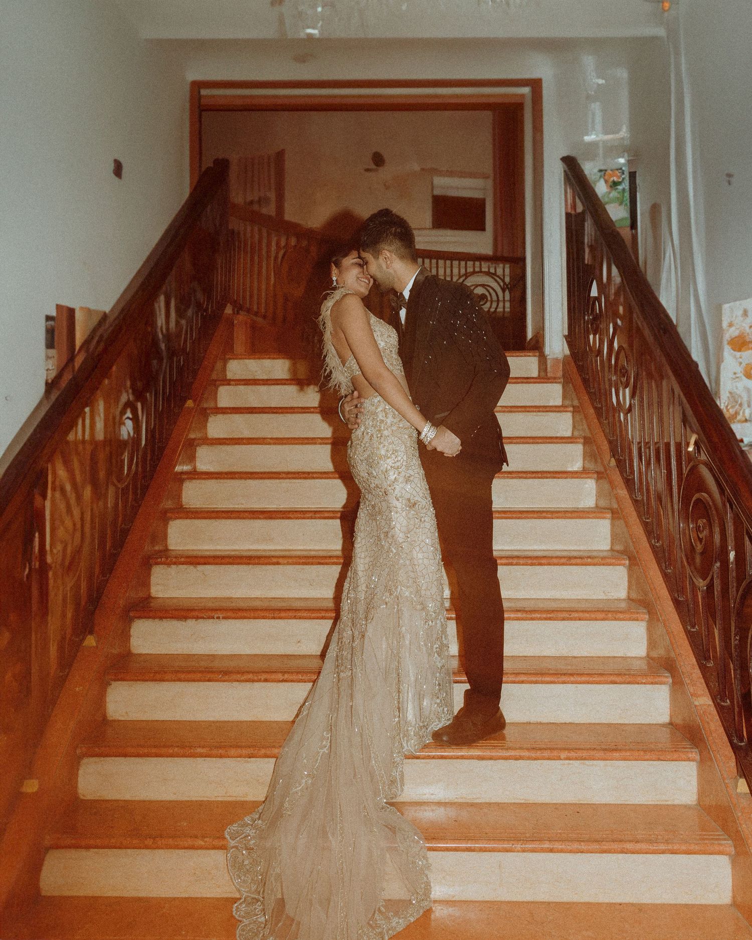 Looking for a wedding photographer in Mumbai? Intimate wooden staircase wedding couple sequence by Mumbai's finest wedding photographer.