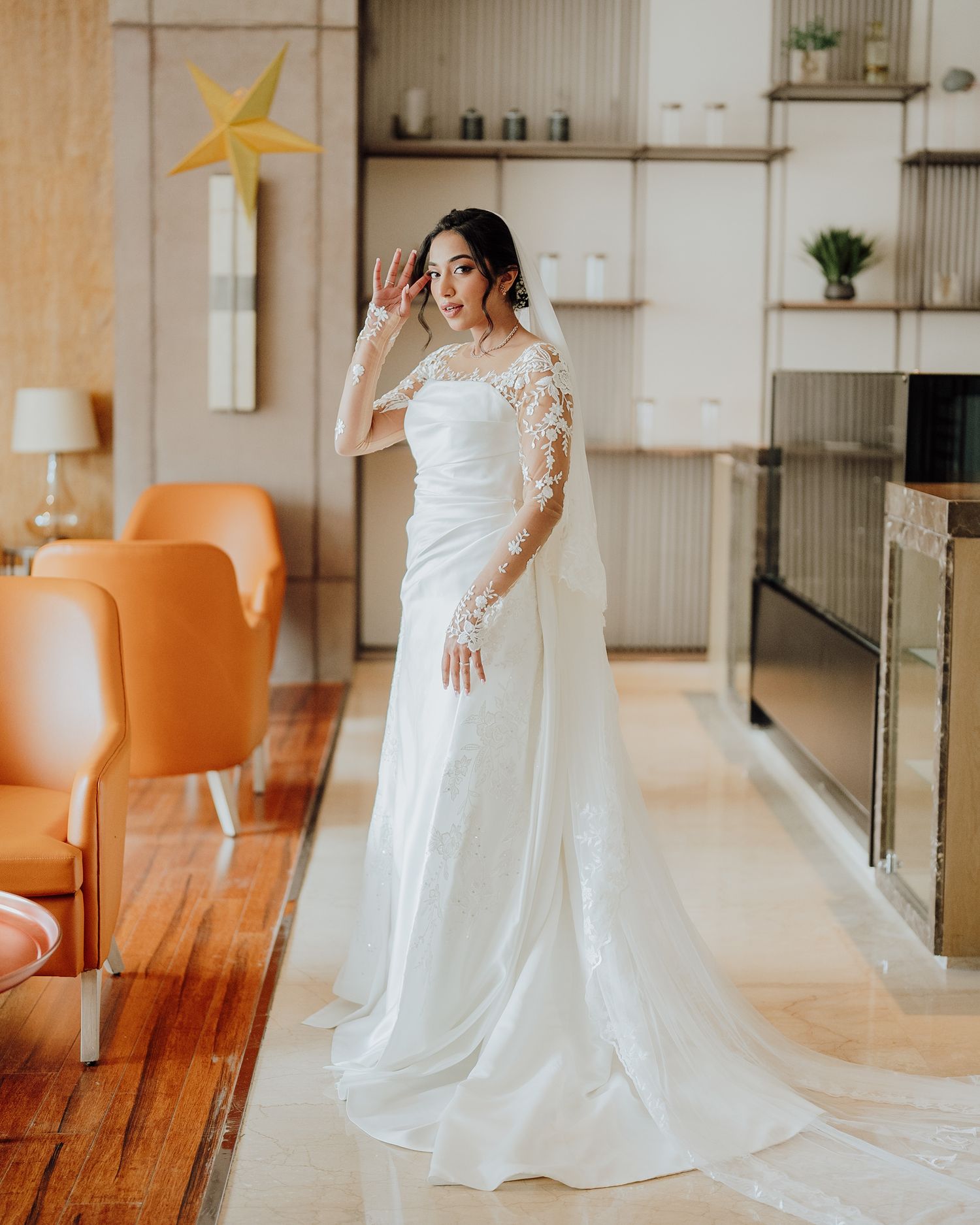 Stunning white lace bridal gown with long sleeves & flowing train, elegantly shot by a trusted wedding photographer near me in Mumbai.