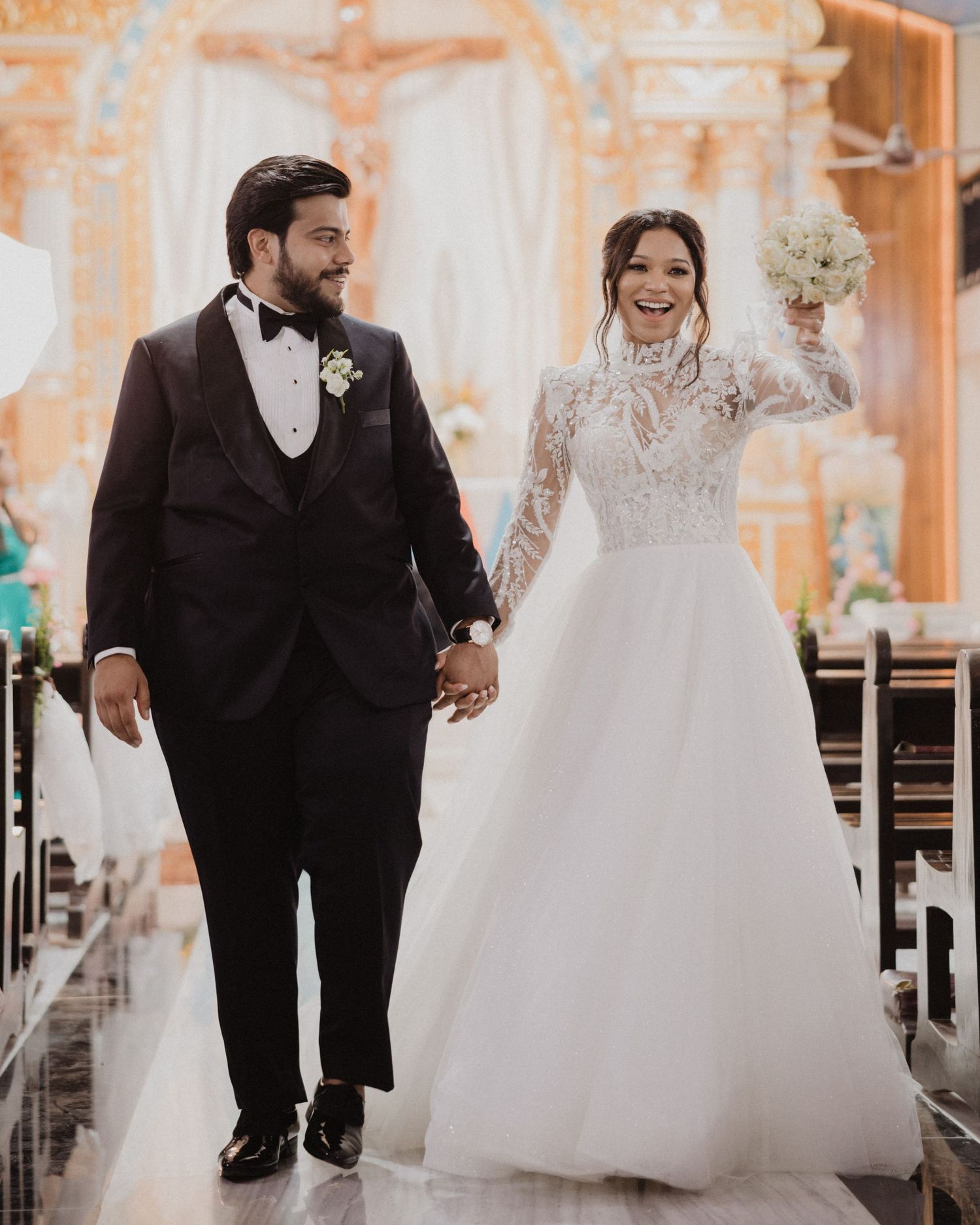 Looking for a wedding photographer in Mumbai? Elegant indoor venue couple walk captured by Mumbai's finest wedding photographer.
