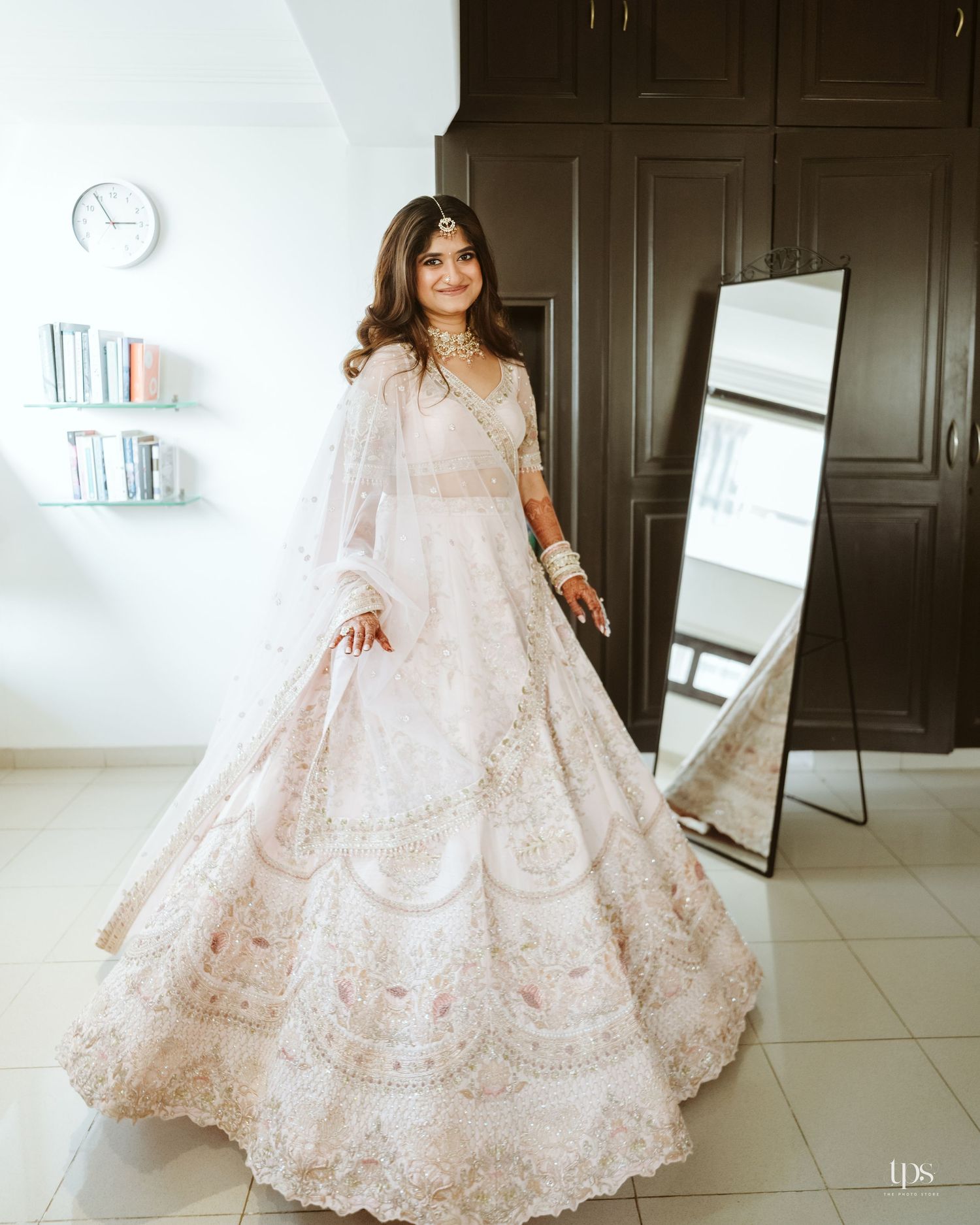 Blush pink embroidered lehenga with intricate details, shot in a modern interior by a wedding Photographer in Mumbai.