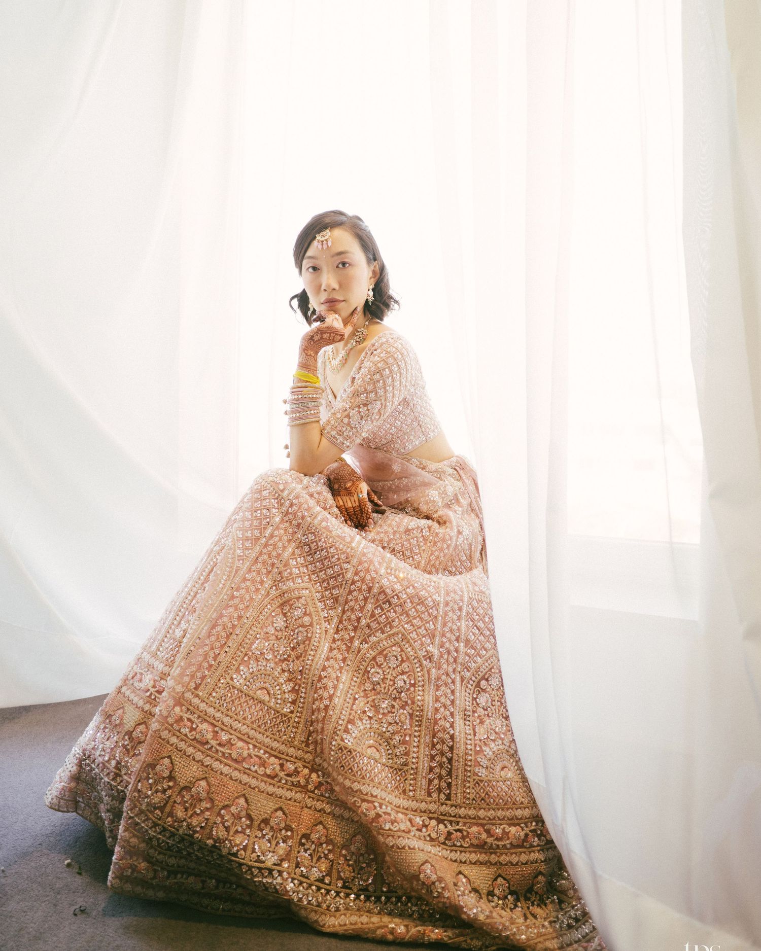 Blush pink lehenga with intricate embroidery in natural light, shot by a wedding Photographer in Mumbai, trusted Wedding photographer Mumbai