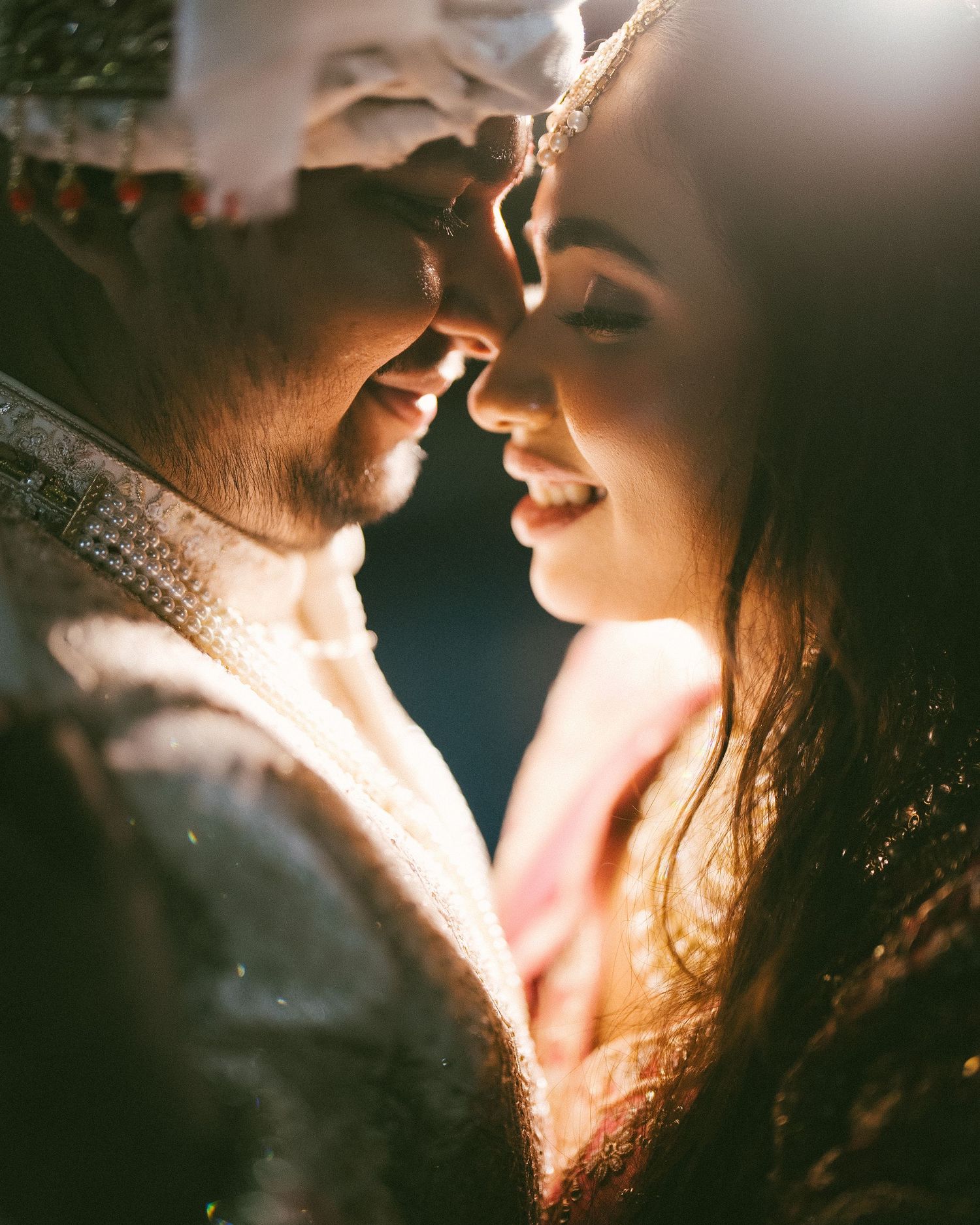 Intimate close-up wedding portrait in traditional attire with dramatic light by a wedding Photographer in Mumbai,Wedding photographer Mumbai
