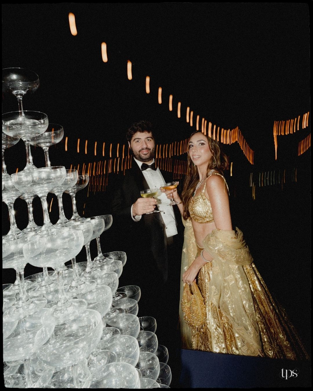 Elegant champagne tower glowing at a wedding celebration, shot by a trusted wedding photographer near me in Mumbai