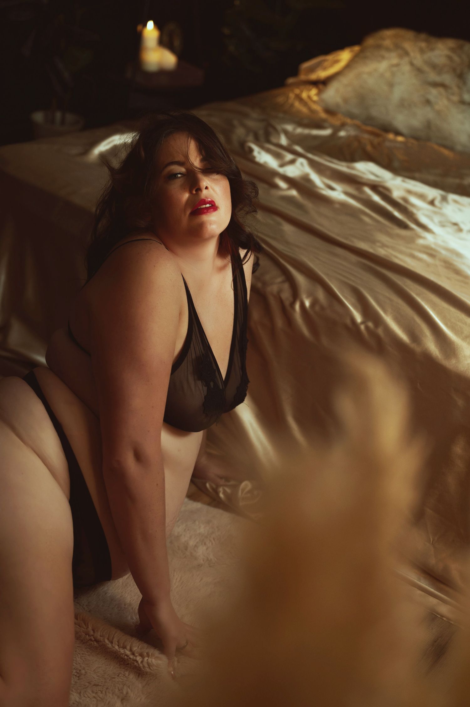 Intimate portrait in dark lighting with candlelight ambiance.