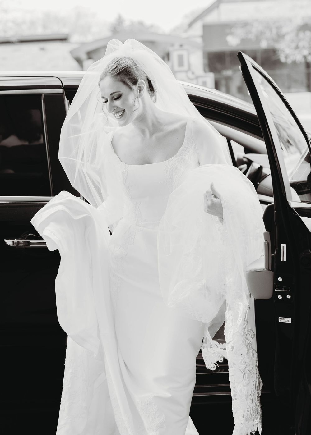 A sequence of black and white photos showing a bride in a flowing white veil getting into a car.