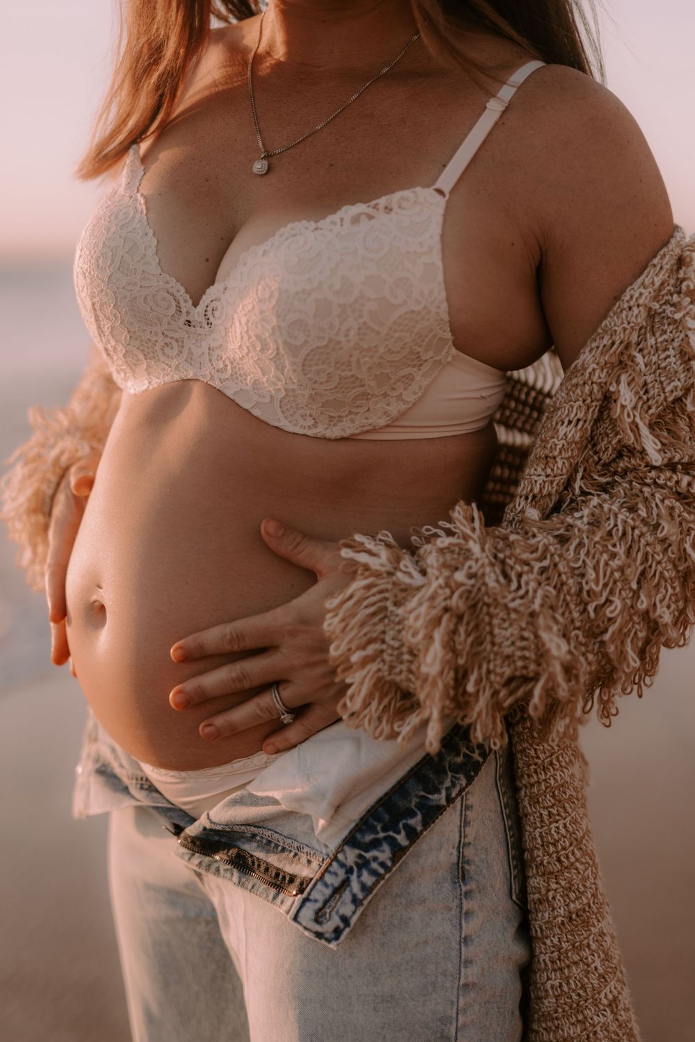 Artistic maternity photos showing pregnancy silhouette against sunset sky.
