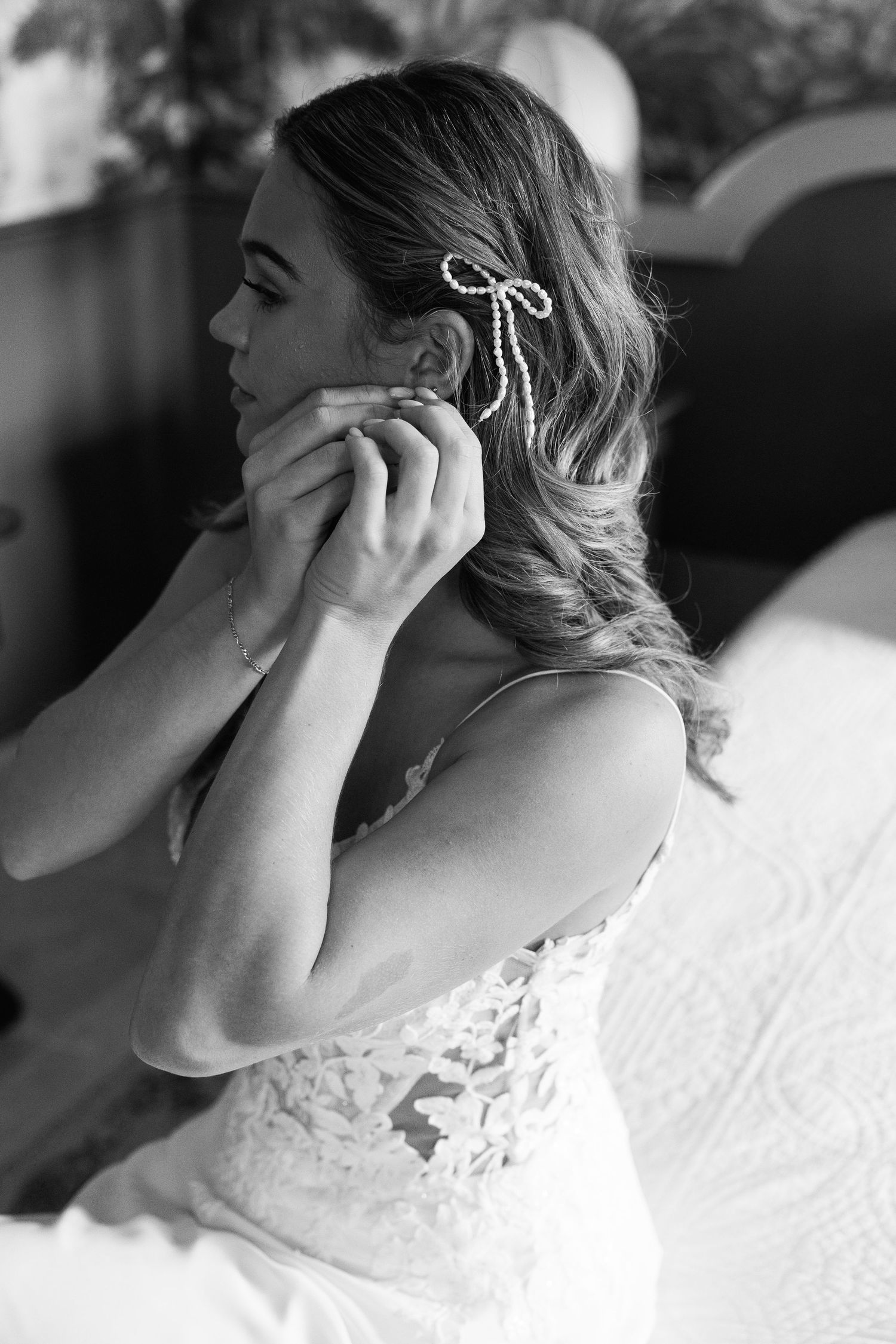 Black and white close-up shots of a bride getting ready with delicate lace details and emotional moments.