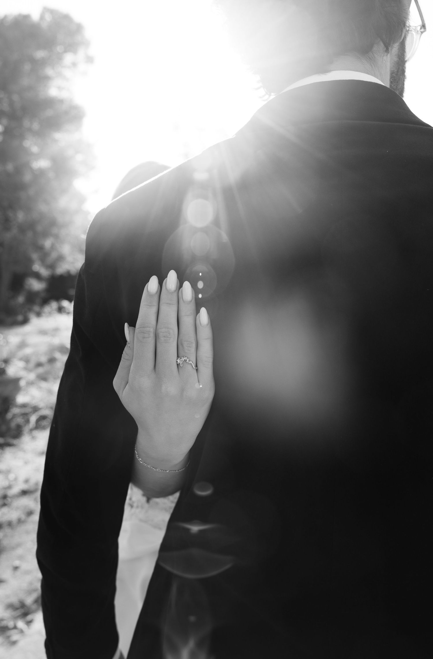 Series of black and white silhouettes with hands blocking sunlight in artistic wedding photography.