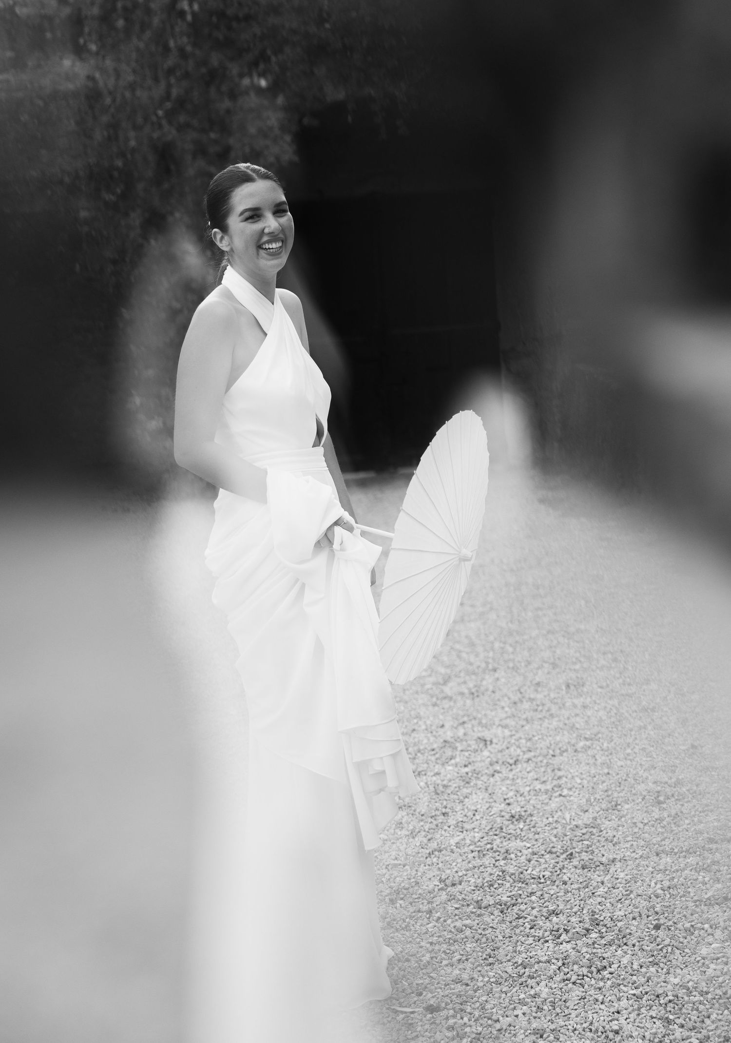 Motion-blurred black and white photos of bride twirling in white dress outdoors.