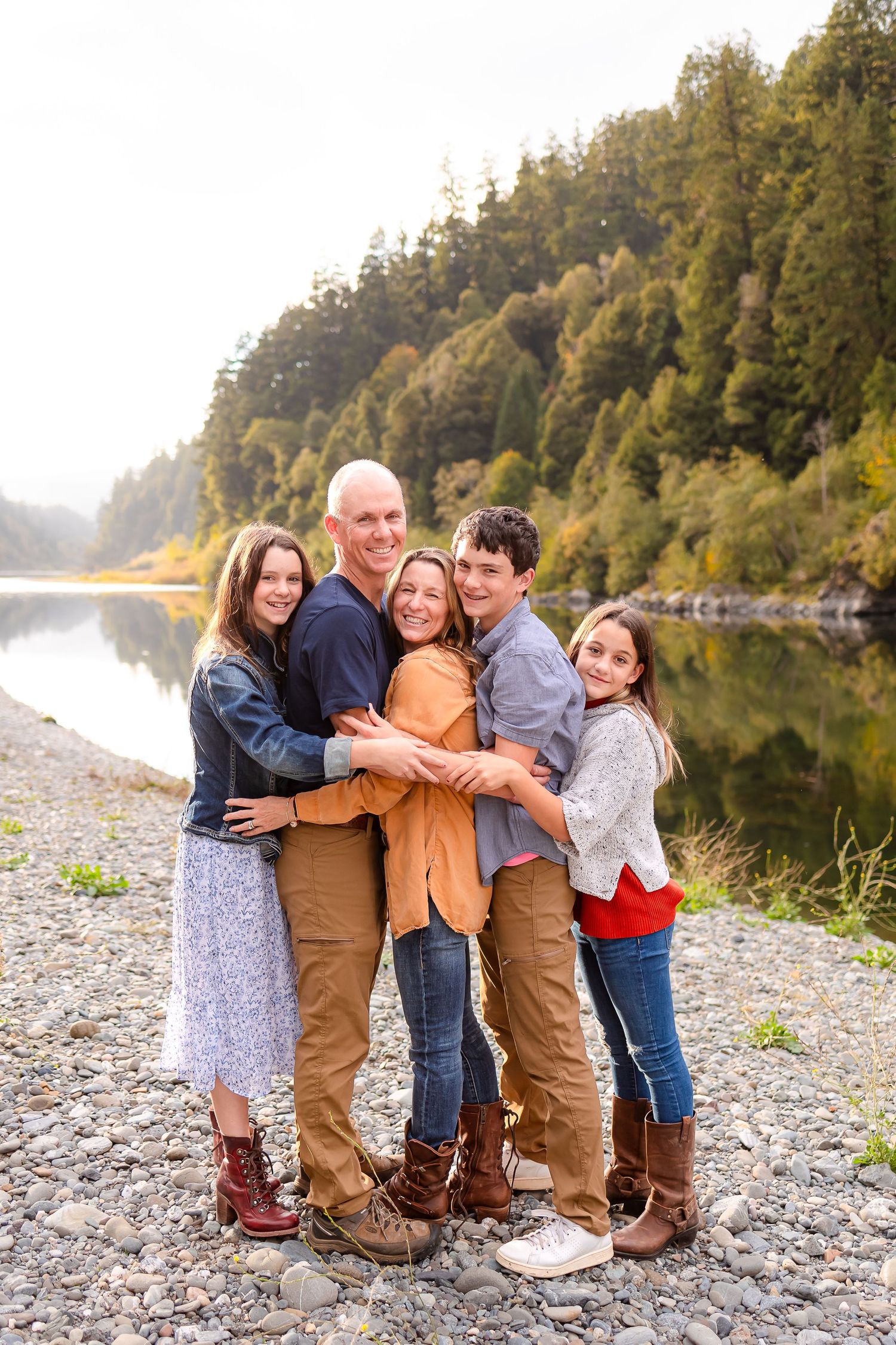 Family getting their photos taken by Taylor Carpenter Photography along the beautiful Rogue River in Gold Beach, Oregon