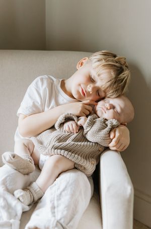 Sweet moment of rest on a light colored couch.