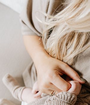 Close-up detail of blonde hair and beige clothing textures.
