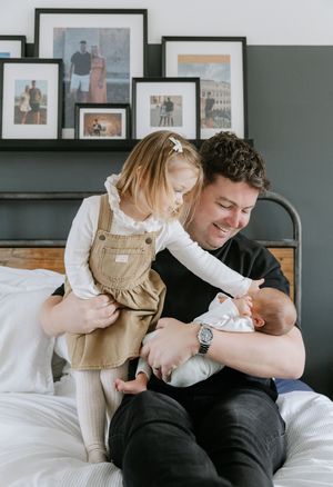 A series of four tender moments between parent and newborn baby on a couch, showing gentle interaction and bonding.