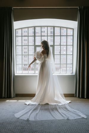 A series of six artistic wedding dress photos showing flowing white fabric against large windows in an elegant room.