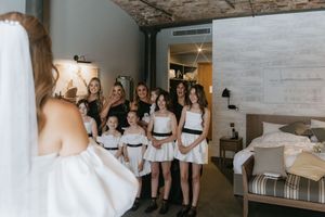 A series of wedding preparation photos showing bridesmaids in white robes getting ready for the special day.