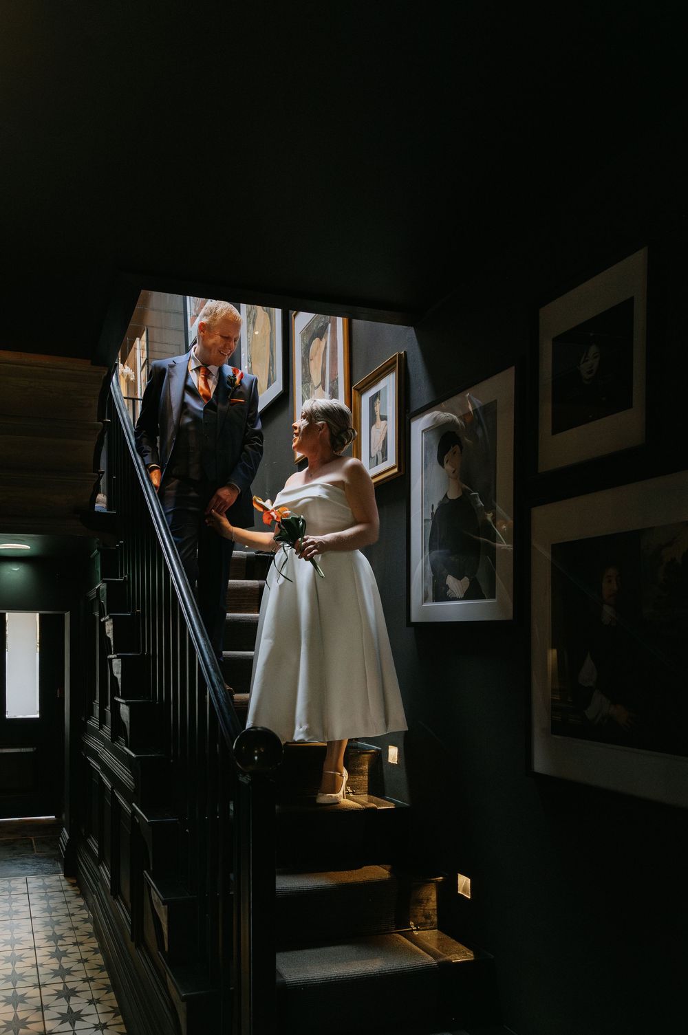 A series of dramatic shots showing a figure descending a dark staircase in a white dress, creating moody shadows.
