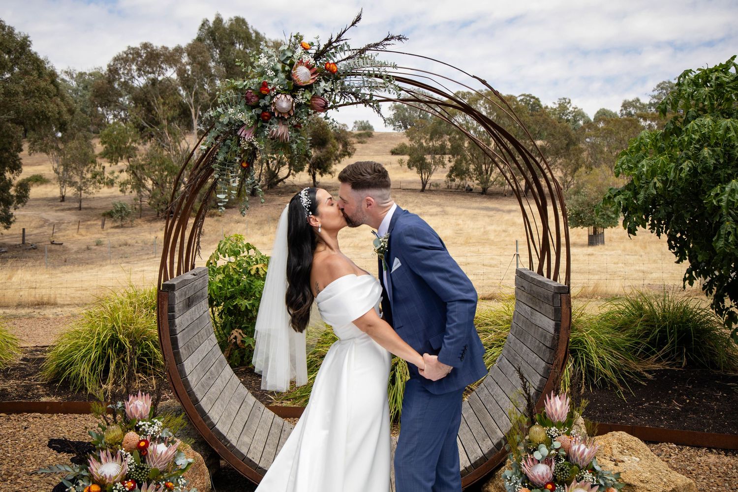 Rustic outdoor setting with vintage wagon wheel and weathered barn door.